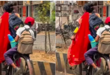 Photo of  चिलचिलाती धूप में बच्चों को साइकिल पर बैठाकर स्कूल ले जाती दिखी मां